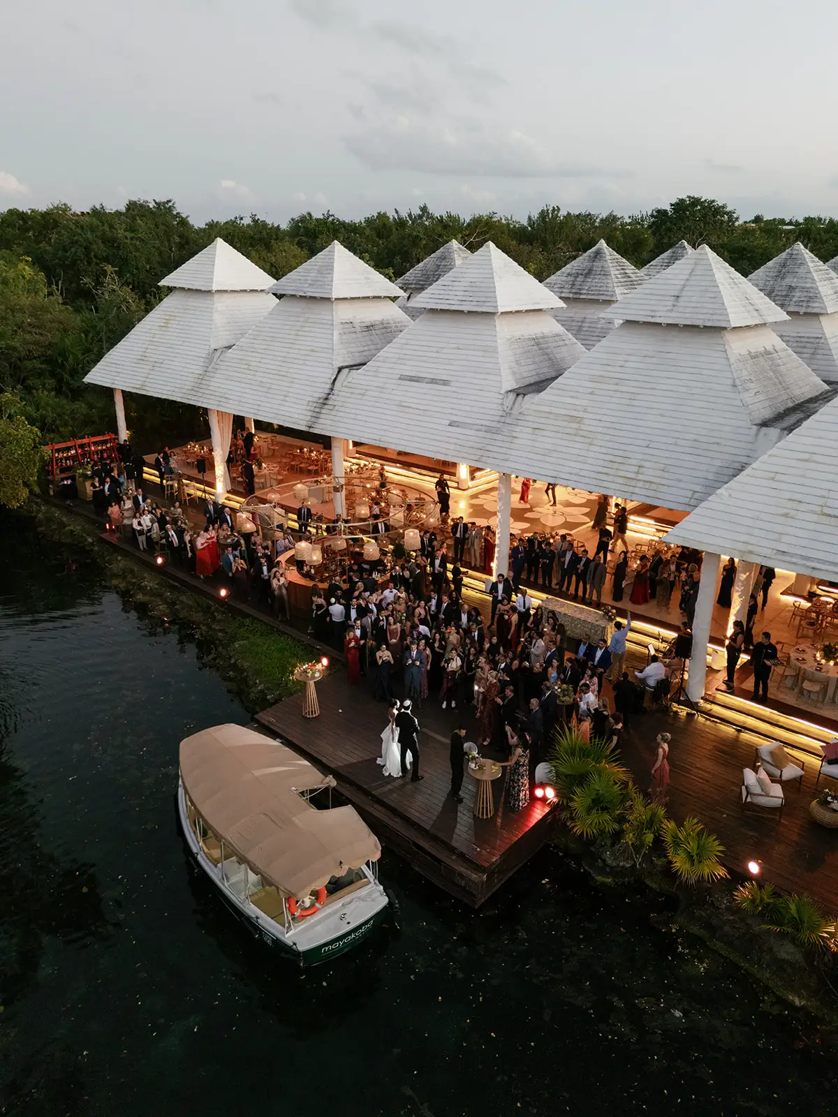 Aerial view of the wedding reception by the lagoon in Mayakoba at dusk